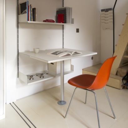 Shelving above desk for home office, modular strong metal. Minimalist studio design. Designer Dieter Rams