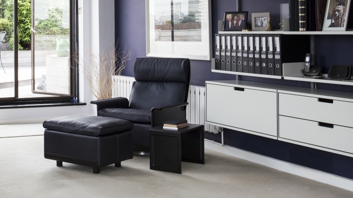 TV stand floating cabinets and 620 reading armchair with footstool. 621 nesting Side Table. Vitsœ 606 modular shelving system, designer Dieter Rams