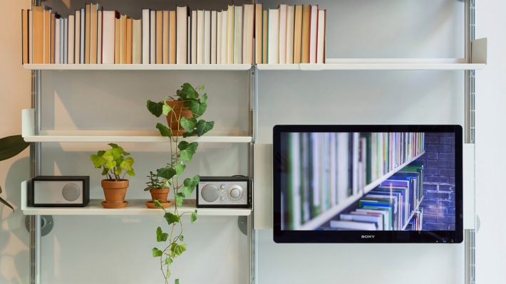 TV/ computer screen mounted panel. Modular shelving system with bookshelves. Wood lacquered in white